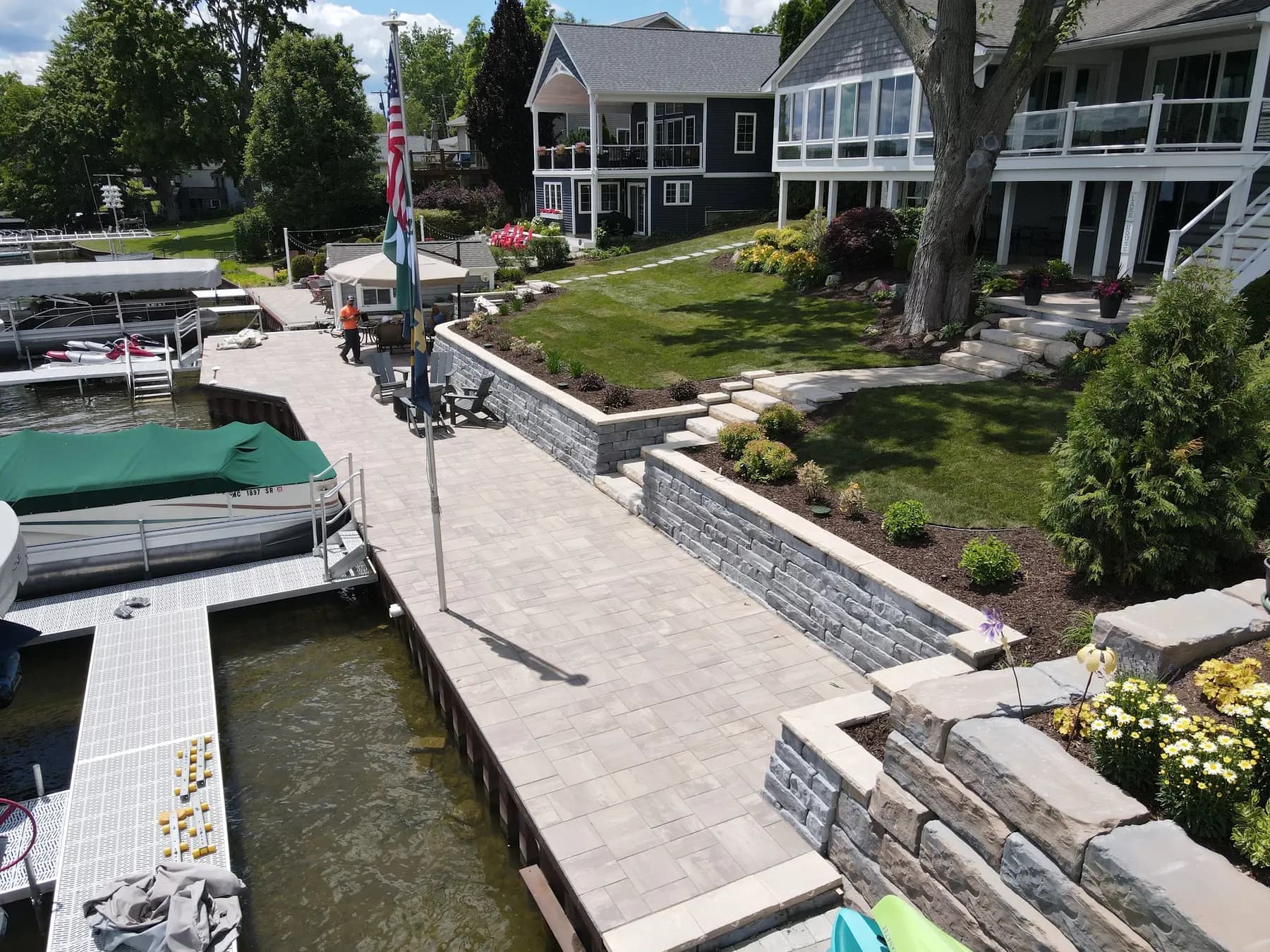Stone retaining walls and steps along a landscaped waterfront property